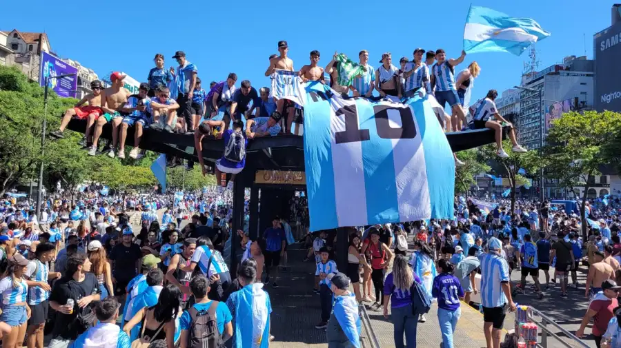 Hinchas argentinos celebrando en una fan zone de 90 Futgol